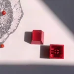 Gallery of premium red aluminum R4 mechanical keycaps, highlighting their vibrant whimsy and iconic metallic craftsmanship from various perspective angles.