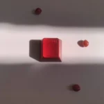 Vibrant red aluminum keycap, an R4 mechanical marvel, exquisitely crafted with a whimsical design, highlighting its premium metallic artisan.