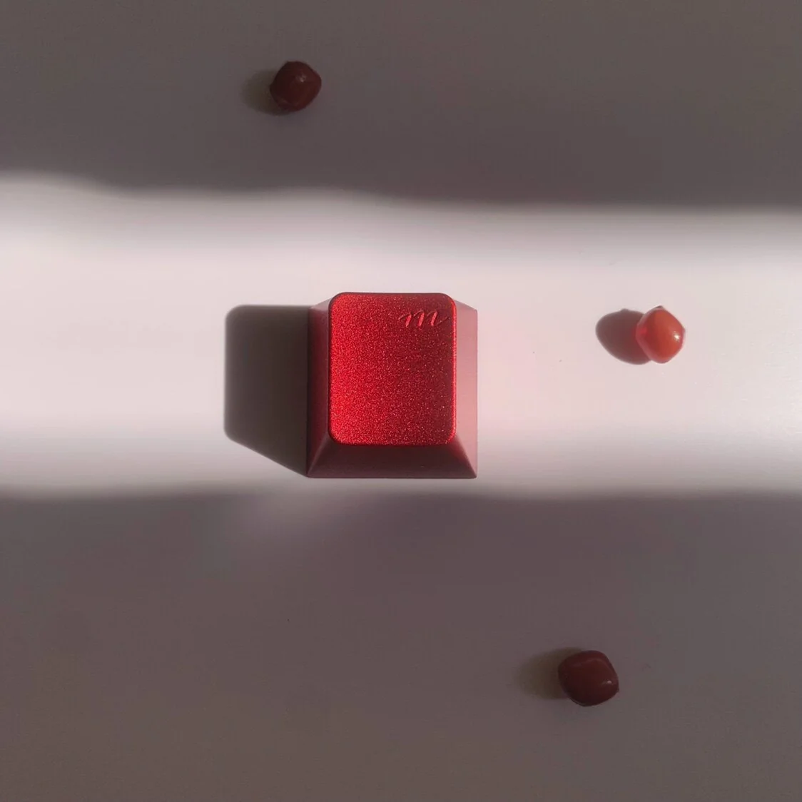 Vibrant red aluminum keycap, an R4 mechanical marvel, exquisitely crafted with a whimsical design, highlighting its premium metallic artisan.