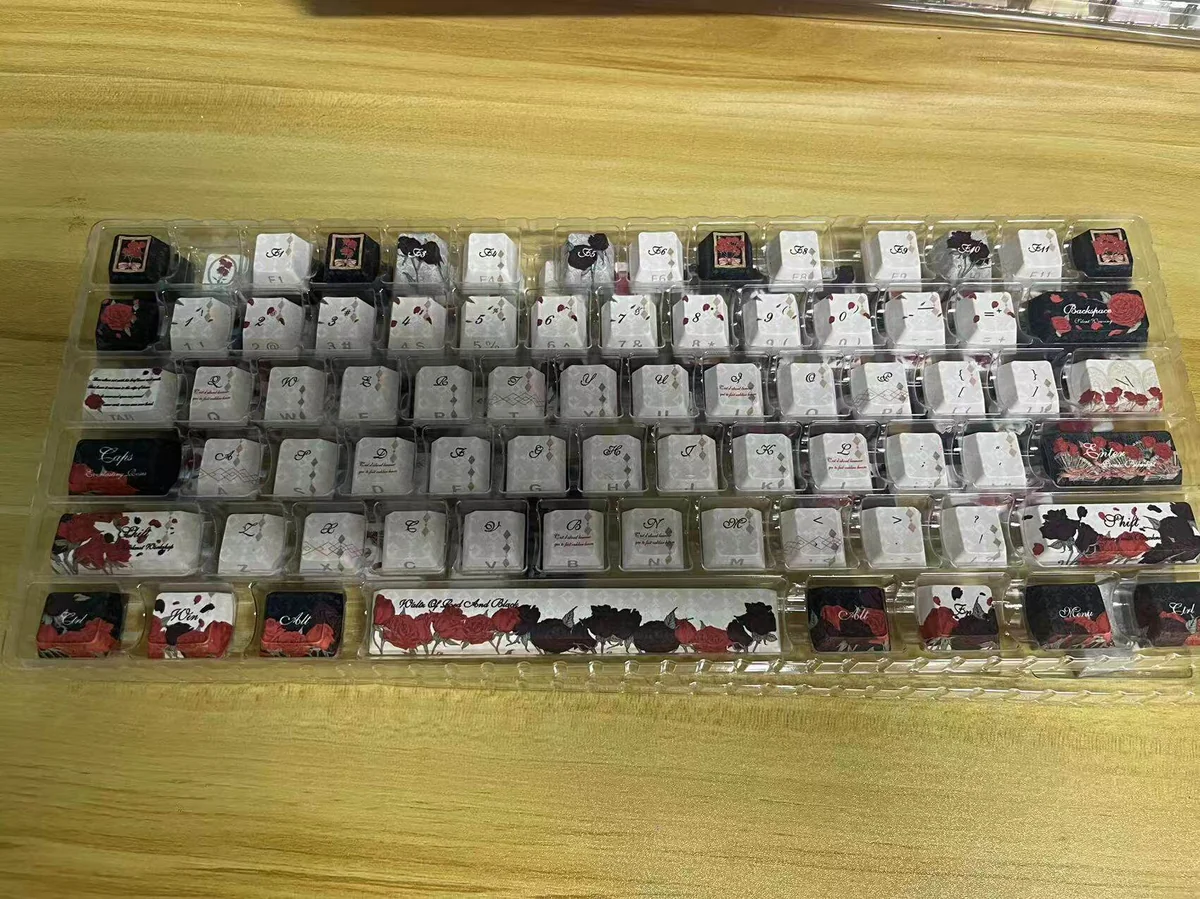 Detailed view of the Red & Black Rose PBT Dye-Sub Keycap Set, revealing the durable PBT and striking gothic rose patterns from an artistic perspective view.