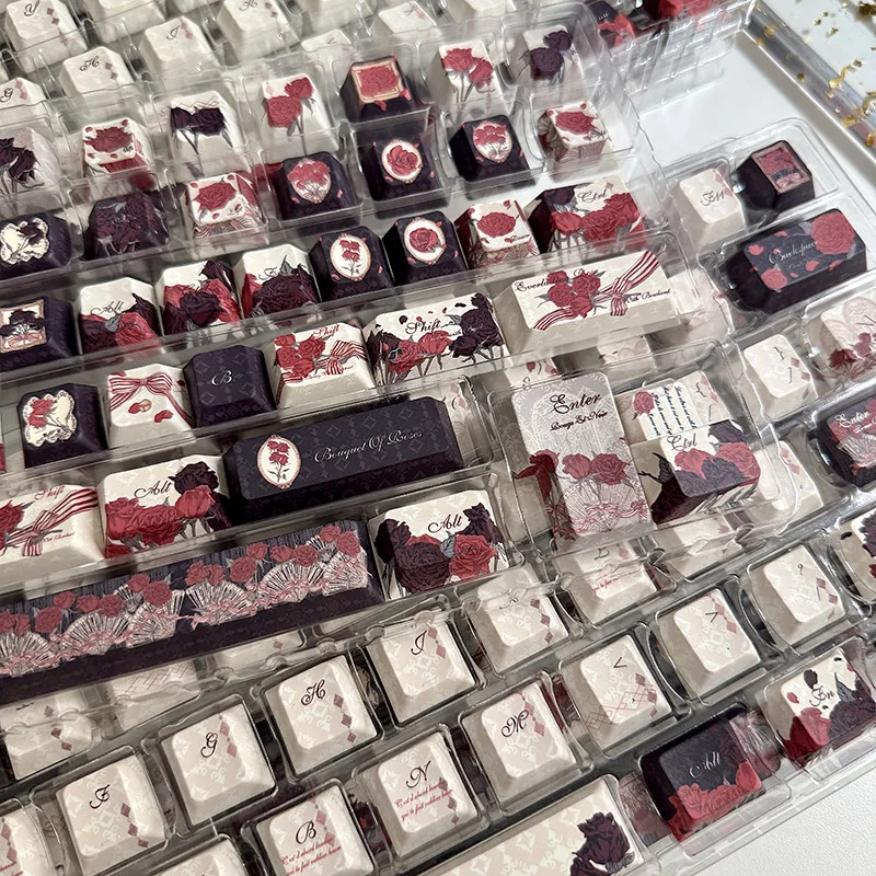 Artistic red and black rose PBT keycaps set in new profile, showcasing dramatic gothic elegance and intricate floral designs for a striking keyboard.