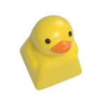 Close-up views of a whimsical handcrafted resin little yellow duck keycap, showcasing its playful charm and unique artistic details from various angle.