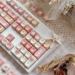 Close-up of the Rilakkuma MOA profile PBT keycaps set, showcasing pastel colors and whimsical character details from a unique angle.