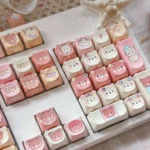Rilakkuma MOA PBT keycaps set. Whimsical pastel Rilakkuma & Kaoru design. Durable, ergonomic keycaps shown from multiple angles for a cozy design.