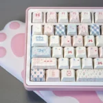 Elegant Rococo PBT Dye-Sub Keycap Set from a fresh angle, revealing ornate pastel designs, intricate scrollwork, and natural motifs. Elevates any opulent design.