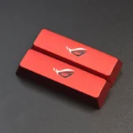 Multiple angles of the Republic of Gamers: ROG Logo Split Space Key Keycaps, showcasing its bold, aggressively sculpted metallic design for an ultimate gaming setup.