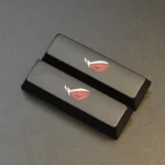 Two black Republic of Gamers: ROG Logo Split Space Key Keycaps, featuring an aggressive, sculpted gaming design for an elevated setup.
