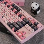 A collection of Sweetheart Black Pink Romantic PBT Keycaps Set, showcasing the adorable MOA profile and durable design from various playful angles, perfect for fans.