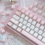 Exquisite Rose Whisper PBT Dye-sub Rose Keycap Set, showcasing delicate rose motifs and soft romantic hues. An artistic close-up for a serene desktop.