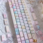 Vibrant pastel Sailor Moon keycaps in a 130-key PBT Dye-Sub set, displayed from an overhead angle, highlighting iconic characters and magical motifs.