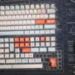 Detailed view of the Artistic Salmon PBT Keycaps Set, showcasing vibrant dye-sublimated oceanic hues and playful textures on an Cherry profile keycap.