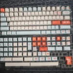 Vibrant Salmon PBT Keycaps Set, dye-sublimated with artistic salmon-inspired colors and oceanic hues, creating a fresh desk aesthetic. Cherry Profile.