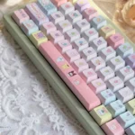 Joyful PBT dye-sub Sanrio keycap set, viewed from various angles. Showcases vibrant Hello Kitty, My Melody, and Cinnamoroll for kawaii keyboards.