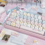 Close-up view of the iconic Sanrio PBT keycaps set, showcasing multiple vibrant character designs from various playful angles.