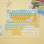 Shallow Dream PBT Keycaps set viewed from an ergonomic angle, showcasing the ethereal pastel sky and cloud motifs. Durable and dreamily designed.