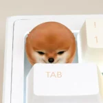 A charming handcrafted Shiba Inu ESC keycap, playfully guarding your keyboard with its cute presence. Perfect for tech enthusiasts.