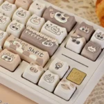 Charming Siamese Cat PBT Keycap Set showcasing whimsical stylized feline designs in warm cream and brown, perfect for unique keyboards.