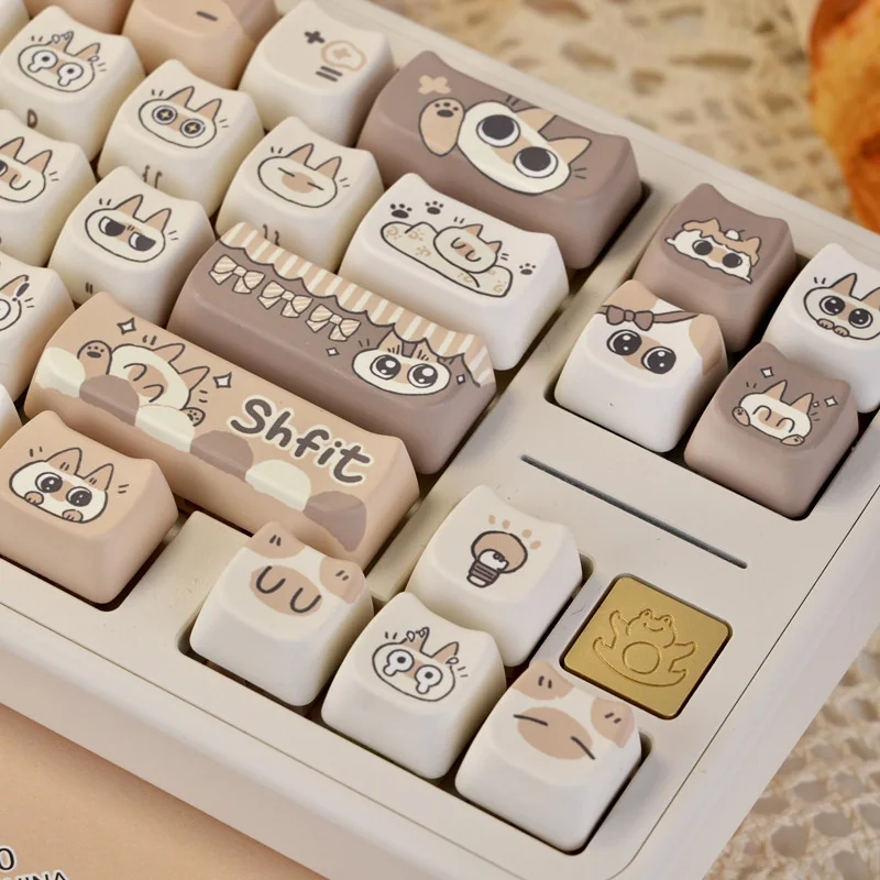 Charming Siamese Cat PBT Keycap Set showcasing whimsical stylized feline designs in warm cream and brown, perfect for unique keyboards.
