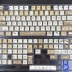 Charming Azukisan Siamese Cat PBT keycaps set, showcasing the whimsical stylized cat motif in warm cream and brown tones, highlighting the endearing artistic view.