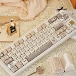 Charming Siamese Cat PBT Keycap Set, showcasing whimsical stylized feline designs in warm cream and brown, perfect for custom keyboards.