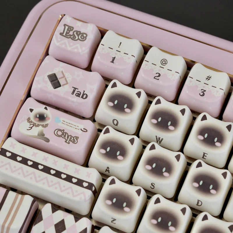 Close-up of the adorable pink Siamese cat PBT keycap set, highlighting its whimsical illustration and vibrant colors from a unique angle, perfect for customization.