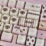 Adorable pink Siamese cat PBT keycap set. This whimsical, vibrant illustration on a durable PBT surface brings a charming, playful touch from a unique angles.