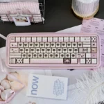 Adorable pink Siamese cat PBT keycap set, playfully illustrated with vibrant colors, showcasing its whimsical charm and durable quality.