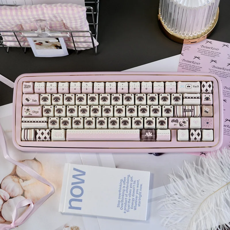 Adorable pink Siamese cat PBT keycap set, playfully illustrated with vibrant colors, showcasing its whimsical charm and durable quality.