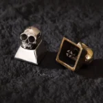 Handcrafted skull artisan keycap for mechanical keyboards, showcasing intricate gothic design and raw metallic luster from multiple angles.