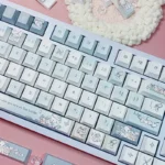 Charming Sleepy Sheep PBT Keycaps set, shown from various angles. Features soft pastel colors, adorable whimsical sheep motifs, premium quality design.