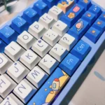 Multiple views of Whimsical Space Bear PBT Dye-Sub keycaps set. Durable, artistic bear astronaut designs in vibrant cosmic scenes. Unique and high-quality design.