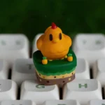 A close-up view of the exclusive Stardew Valley Chicken ESC keycap, showcasing its charming pixel art design and vibrant farm aesthetic from a playful setup.