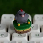 Exclusive Stardew Valley Chicken ESC keycap, featuring a charming pixel art design. This playful gaming decor is shown from a detailed, vibrant angles.