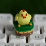 Close-up of the exclusive Stardew Valley Chicken ESC keycap, showcasing its charming pixel art design and vibrant farm aesthetic from a playful angle.