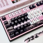 Detailed shot of the unique Statue of Liberty PBT keycap set, highlighting the intricate whimsical girl art in its vibrant hues.