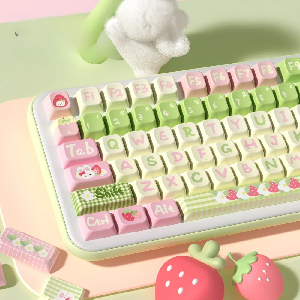 An artistic product gallery view of the Strawberry Milk Rabbit PBT Keycap Set, featuring a charming array of pastel keycaps with whimsical design.