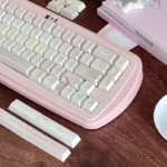 Sweet Strawberry Milkshake PBT Dye-Sub Keycaps Set, captured from a playful angle, highlighting their pastel pink and delightful dessert-themed design.