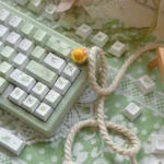 Summer Rain PBT Cherry keycaps set, durable and serene. Multiple angles show soft, ethereal gradients and fluid rain patterns, an artistic keyboard upgrade.