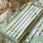 Serene Summer Rain PBT keycaps set, showcasing soft ethereal gradients and fluid patterns. Durable and artistic, these keycaps evoke a gentle summer showcasing design.