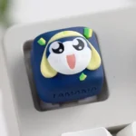 Close-up of a handcrafted Tamama artisan keycap, showcasing its unique resin texture, vibrant colors, and charming 3D sculpt from a detailed side angles.