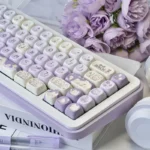 Adorable Taro Paste Kitten PBT dye-sub MOA keycap set, showcased from various angles, featuring playful pastel purple and white kitten and taro paste design.
