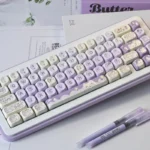 Adorable Taro Paste Kitten Keycaps set, showcasing the complete PBT dye-sub MOA profile in soft pastel purple and white with cute kitten and taro motifs.
