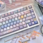 Angled view of unique Twelve Constellation PBT keycaps set, showcasing intricate ethereal designs and a serene, dreamy aesthetic.