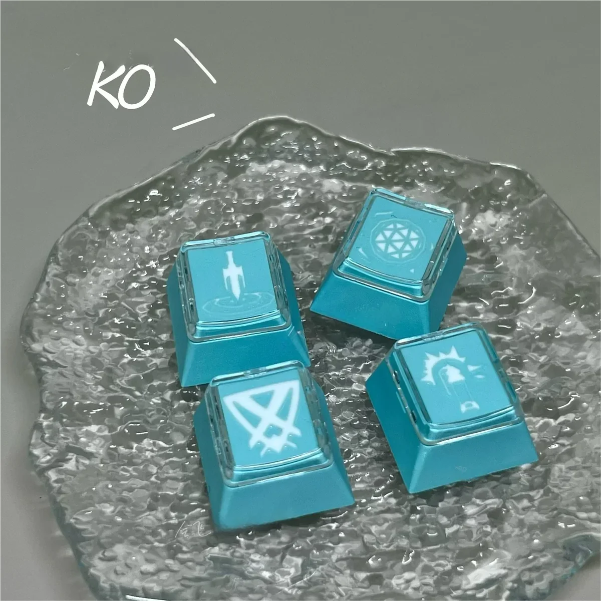 Handcrafted translucent Valorant Kay/O keycaps showcase vibrant resin art and glowing skill energy from various detailed angles.