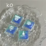 Close-up of a handcrafted translucent Valorant Kay/O skill keycap, showcasing its vibrant resin art and glowing energy from a unique angle.