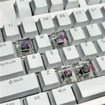 Close-up of artisan handcrafted Valorant Vyse skill keycaps from a different angle, highlighting vibrant translucent details and unique gaming aesthetics.