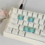 Captivating Valorant Killjoy keycap set, meticulously crafted as translucent artisan pieces from PC resin, exuding a futuristic aesthetic.