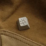 Premium precision CNC Vintage Gear Artisan Keycap for vintage industrial keyboards, showcasing a sophisticated textured linen-like finish.