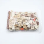 Artistic 143-key Vintage Stamp Keycap Set, PBT dye-sublimated with global journey stamp designs and aged textures, in bag packaging.