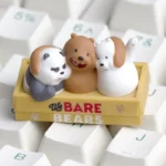 Detailed view of a handcrafted We Bare Bears artisan keycap, featuring Grizz, Panda, and Ice Bear in vivid resin, captured from various playful angle.